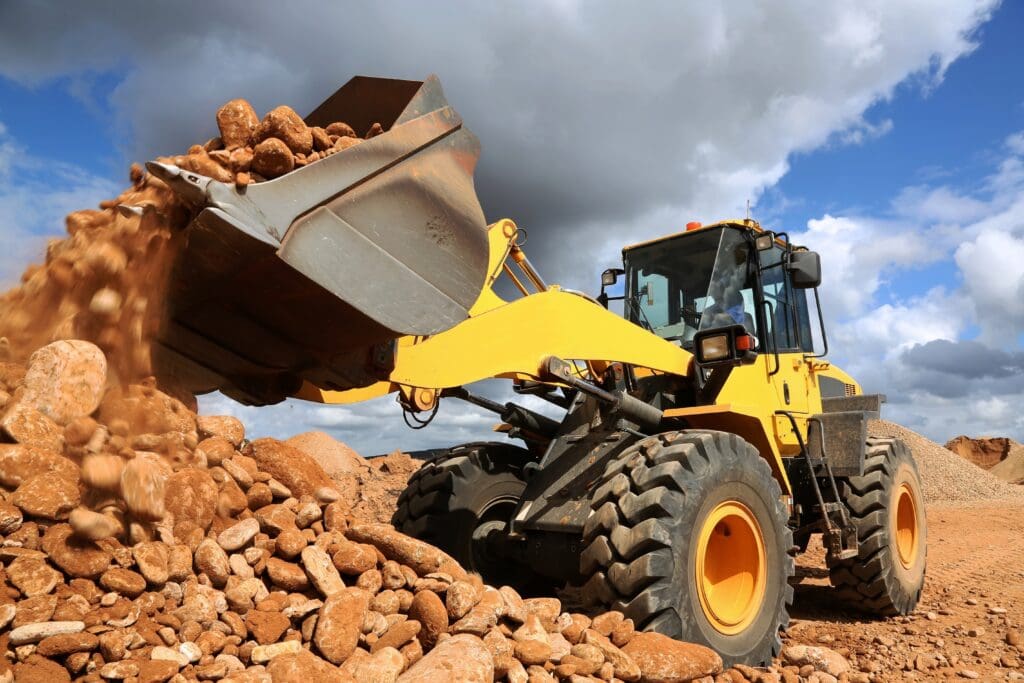 Front End Loader Tipping Stone Front end loader dumping stone and sand in a mining quarry