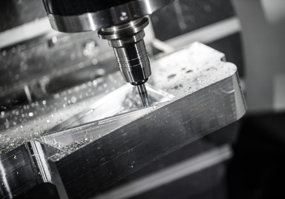 Metalworking CNC milling machine. Metalworking CNC milling machine. Cutting metal modern processing technology. Small depth of field. Warning - authentic shooting in challenging conditions. A little bit grain and maybe blurred.
