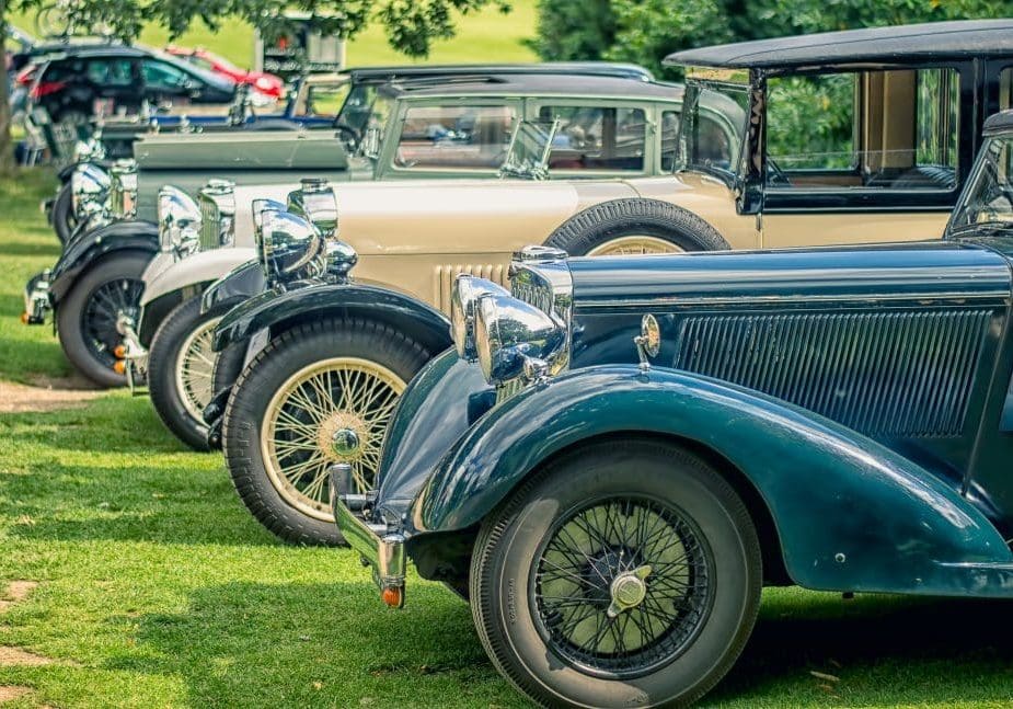 Old classical vintage cars lined up in a row.